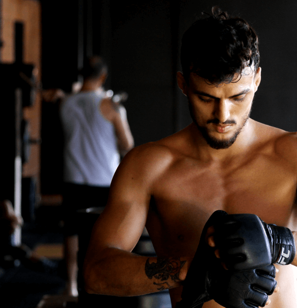 Man preparing for workout in gym.
