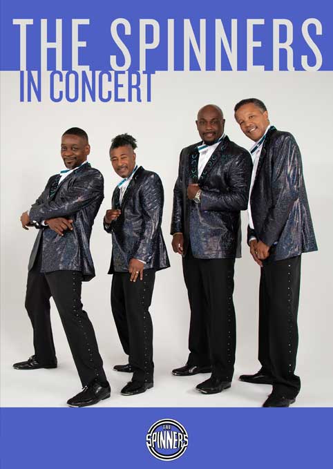 The Spinners band posing in concert attire.