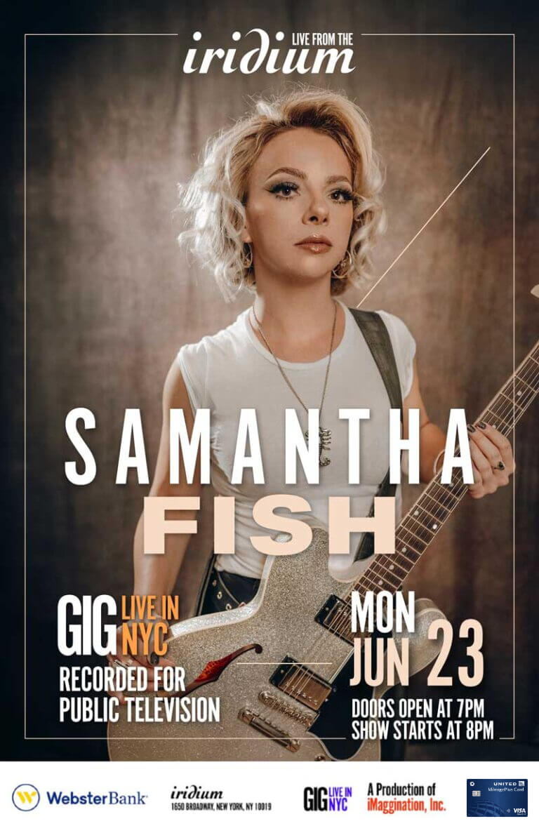 Blonde woman posing with electric guitar concert poster